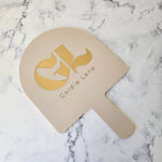 Arch Handheld Mirror Almond Acrylic and Gold Logo