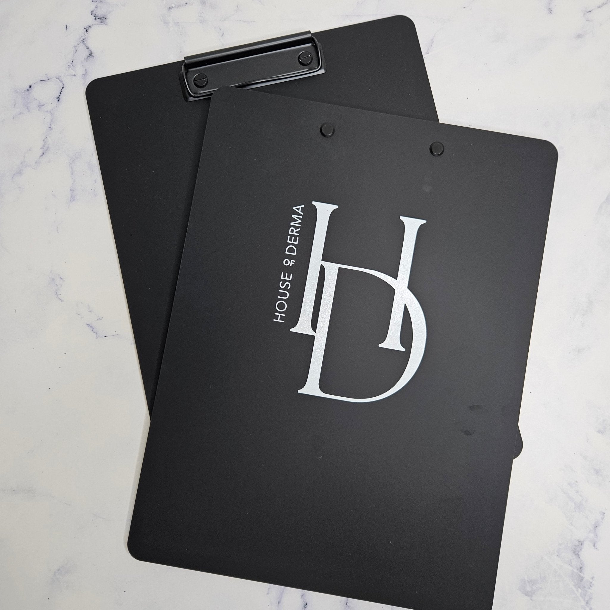 Branded clipboard in black acrylic with white logo