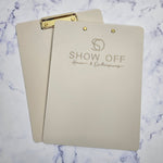 Branded clipboard (beige & metallic gold logo)