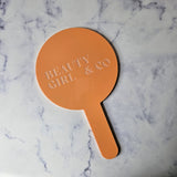 Round Handheld Mirror in Pastel Orange Gloss with Engraved Logo, no colour