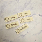 Cream name badge with gold letters