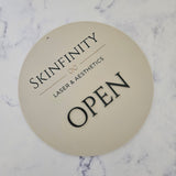 Open sign in round acrylic with black acrylic letters