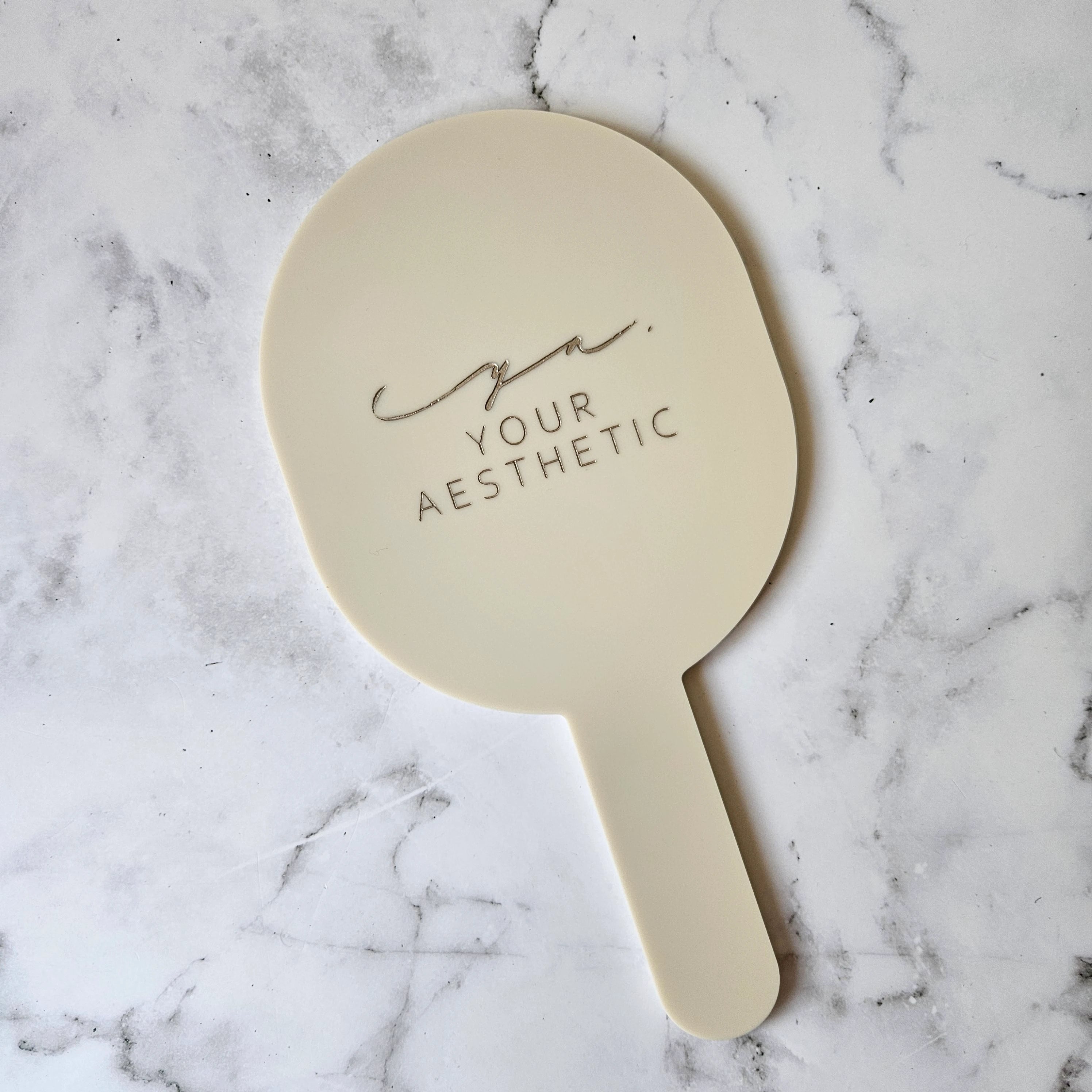 Custom Handheld Mirror in Beige Acrylic and Metallic Champagne Logo