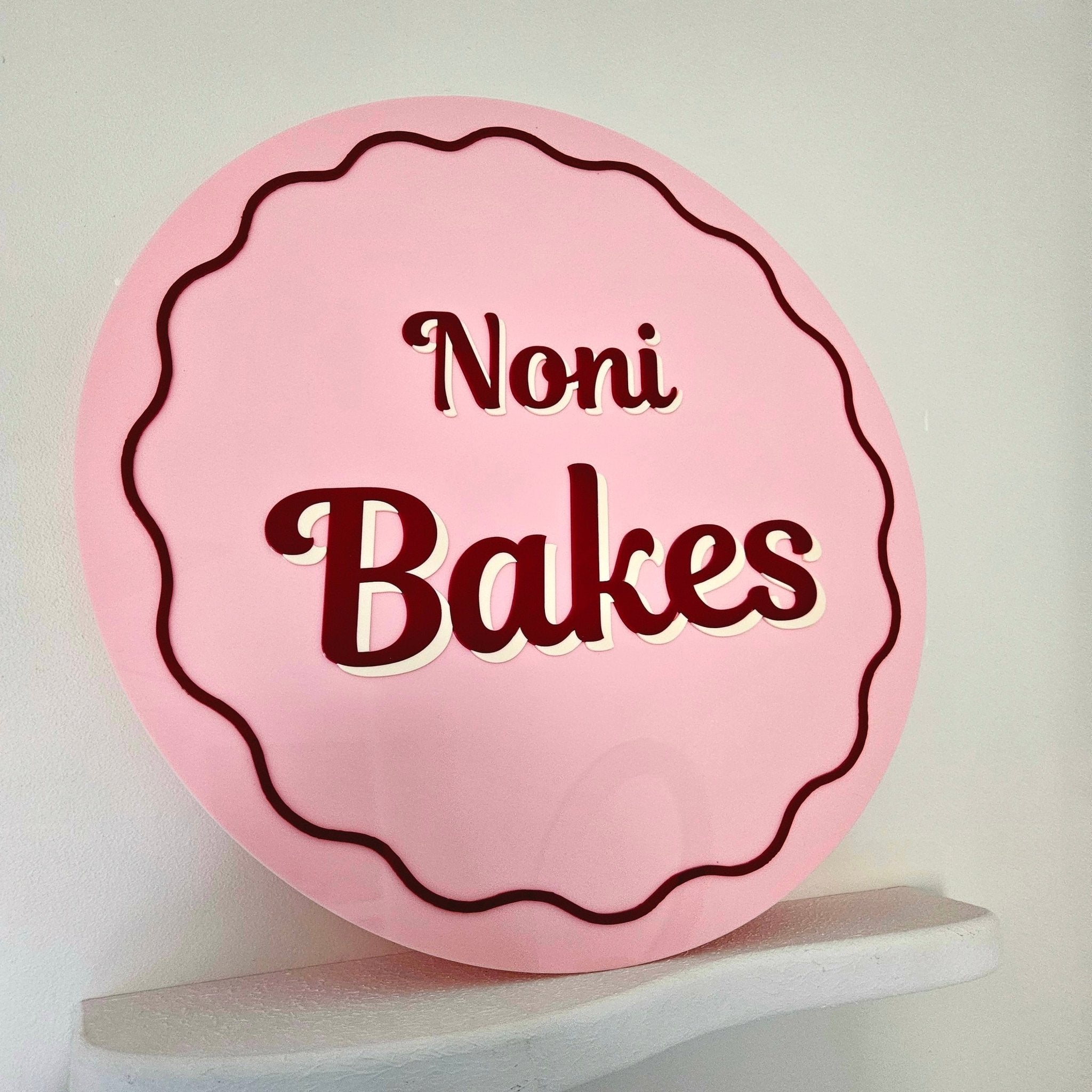 Round business sign (gloss baby blush, ruby & cream acrylic lettering)