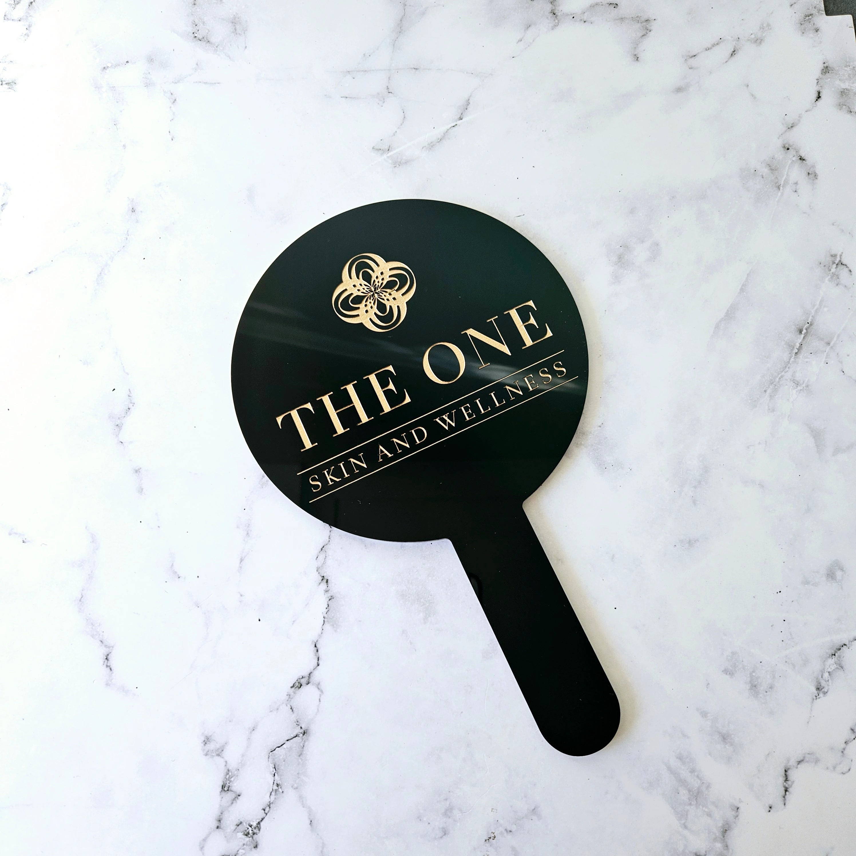 Round Handheld Mirror in Gloss Black and Gold Engraved Logo