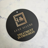 Treatment in progress sign with logo and gold engraving