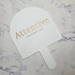 XL Arch Handheld Mirror in white acrylic with Gold Logo