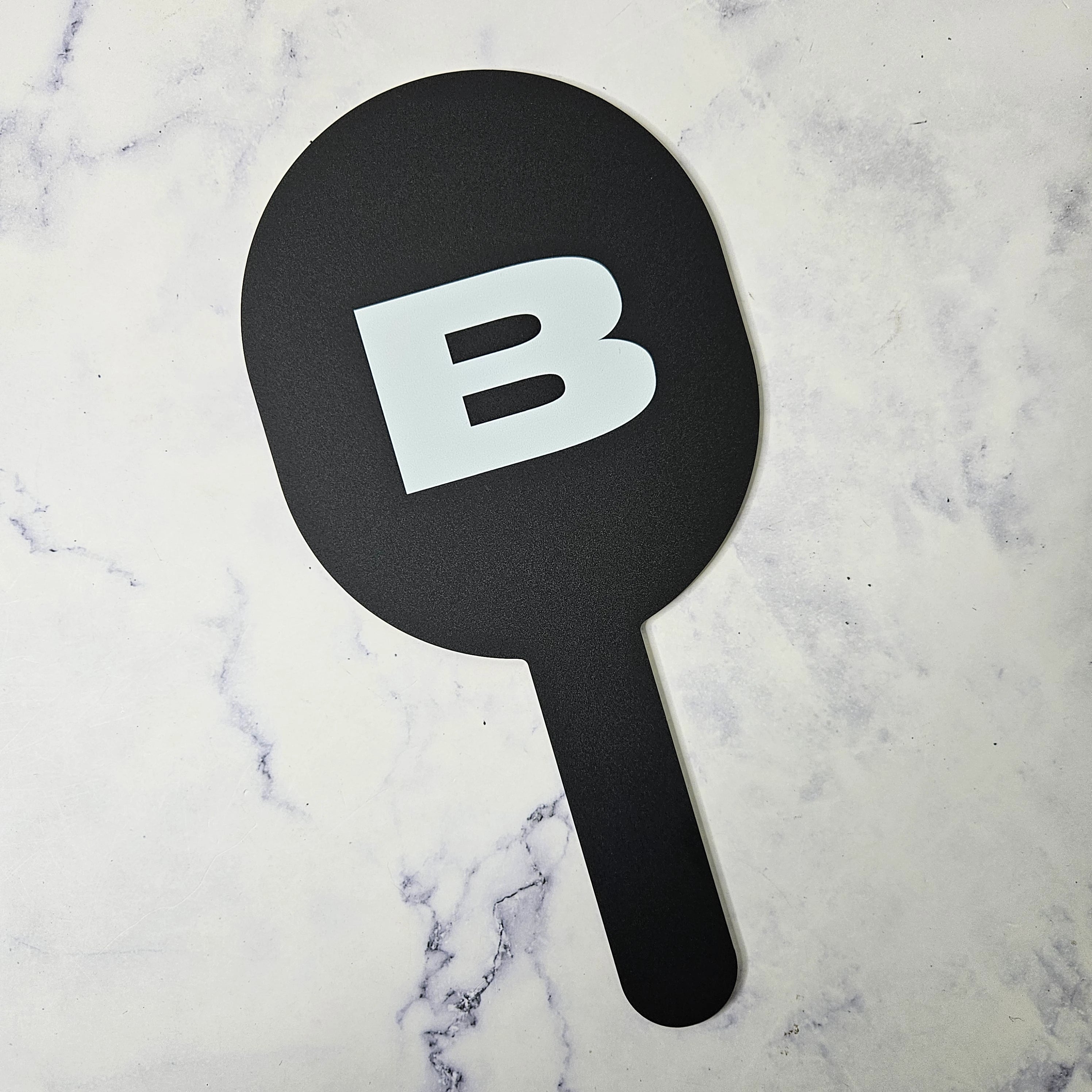 Oval Handheld Mirror in black acrylic with white logo