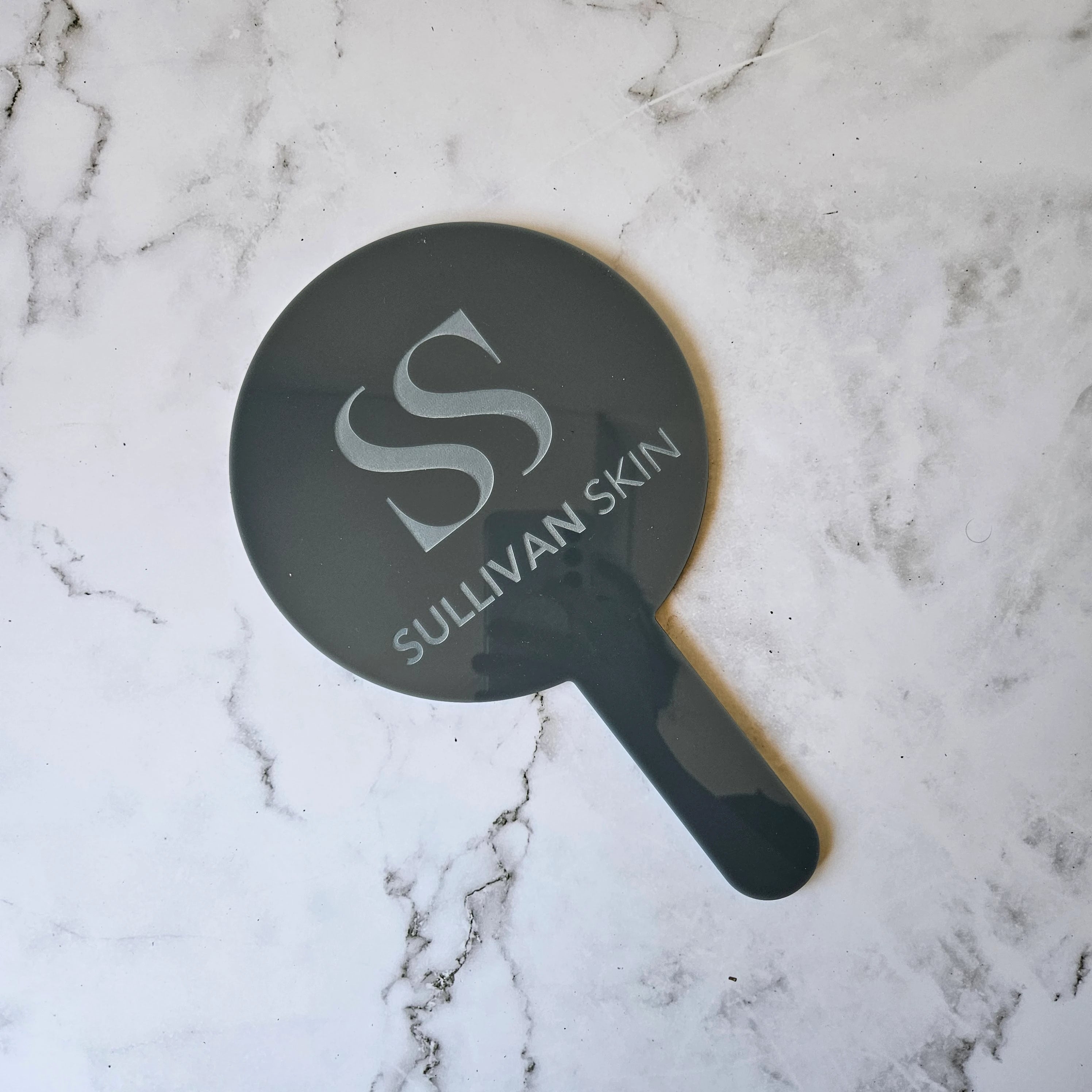 Round Handheld Mirror in Grey (Gloss) Acrylic and engraved logo